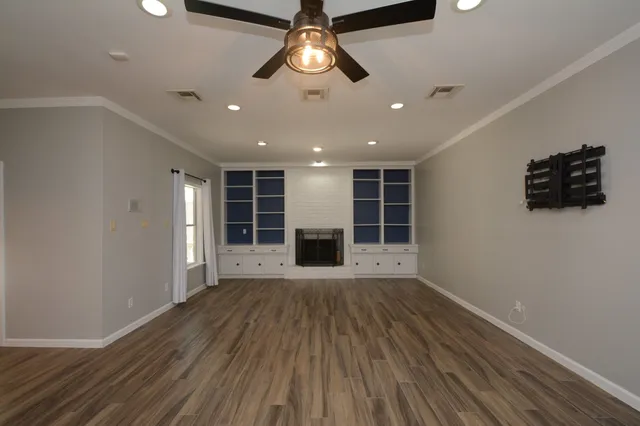 wooden floor in an empty room with a window