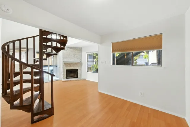a view of a livingroom with an empty space and a fireplace