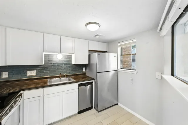 a kitchen with a refrigerator and a sink