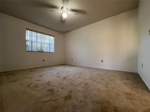 an empty room with a empty space and windows