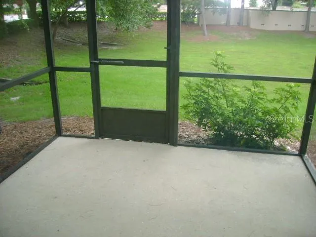 a view of a yard with wooden fence