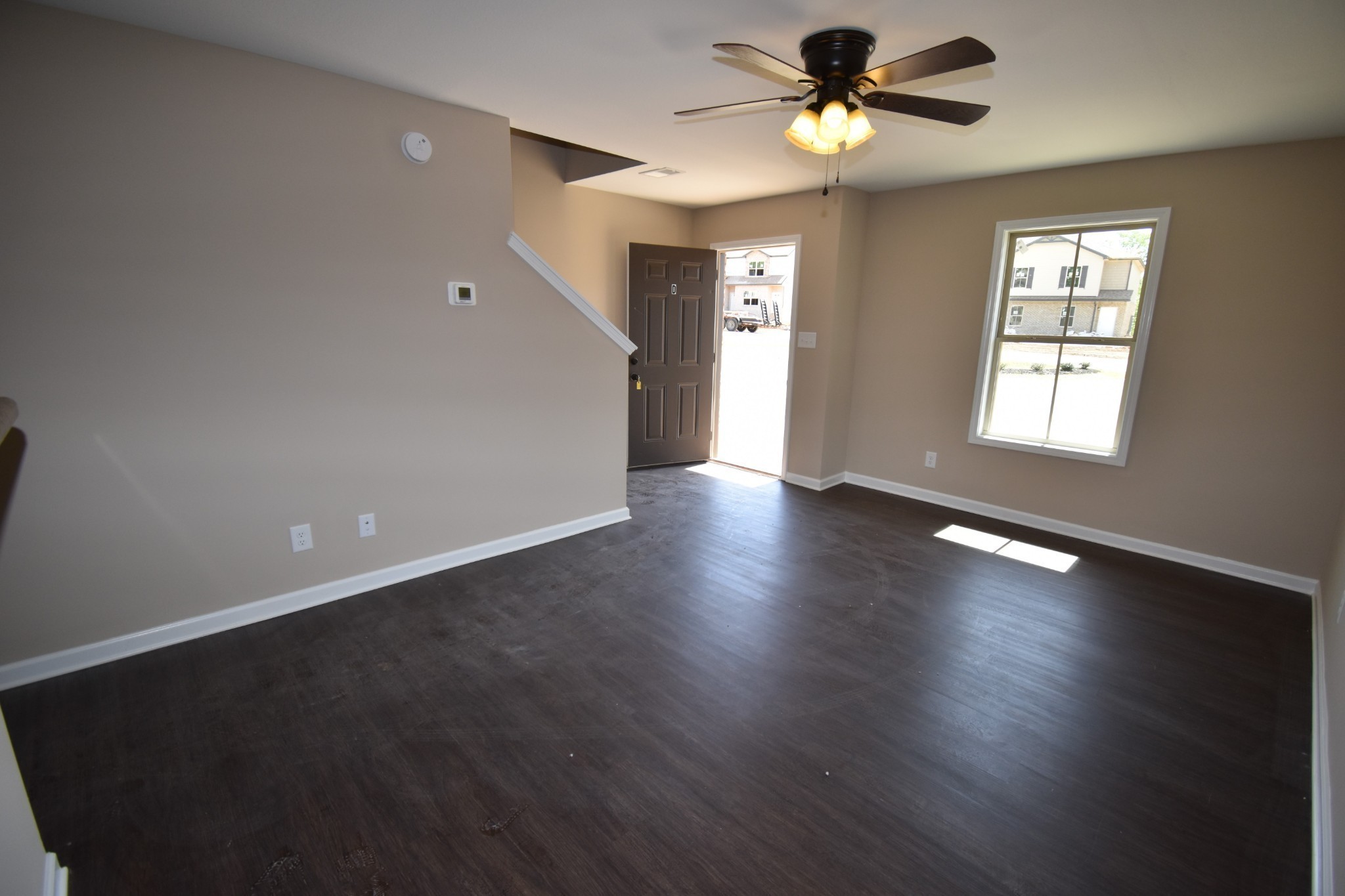 255 Smithson Lane, Unit B Clarksville, TN 37040 - Photo 3 of 21 a view of an empty room with a window and wooden floor