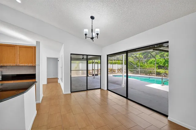 a view of a livingroom with a ceiling fan and window