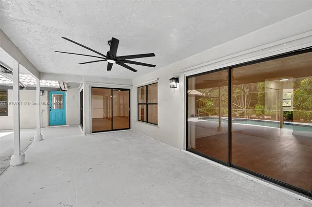 a backyard of a house with table and chairs