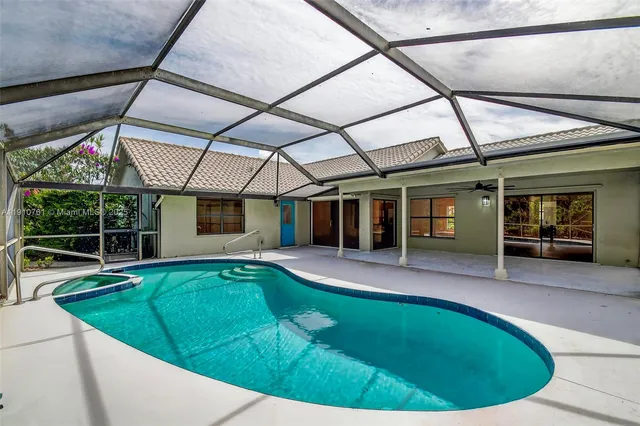 a view of a room with wooden floor fan and windows