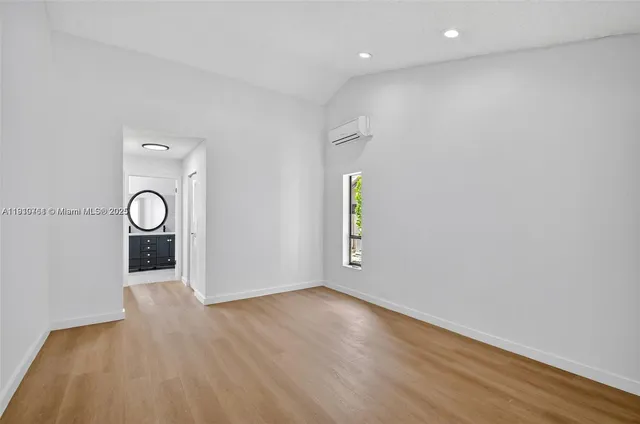a front view of a house with a yard and potted plants