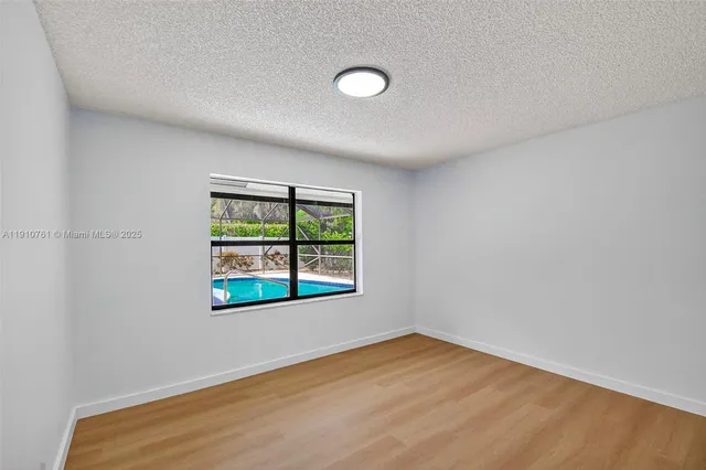 a view of a park with large trees