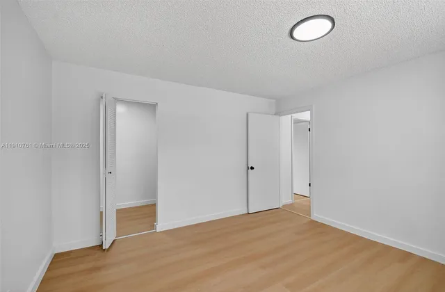 a view of a garden with large trees