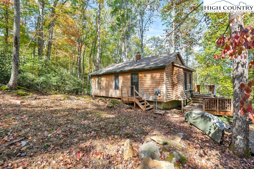 180 Wild Blackberry Hill Road Boone, NC 28607 - Photo 20 of 30 a backyard of a house with table and chairs