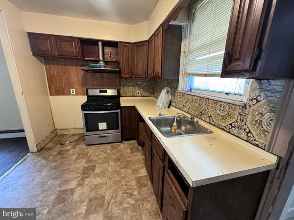 a kitchen with a stove a sink and a microwave