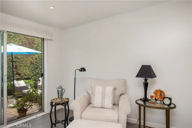 a living room with furniture a fireplace and a large window