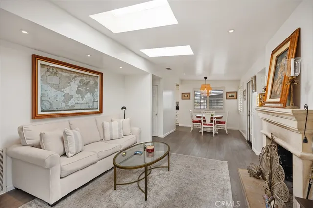 a dining room with furniture a chandelier and window