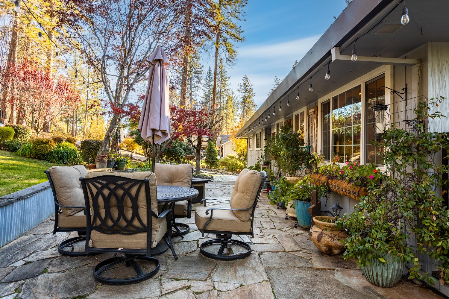 12636 Nottingham Lane Grass Valley, CA 95949 - Photo 2 of 34 a view of a chairs and table in backyard of the house