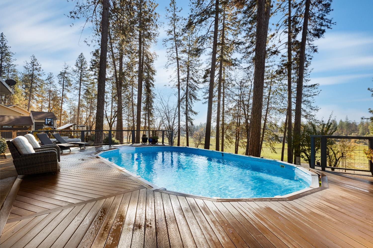 12636 Nottingham Lane Grass Valley, CA 95949 - Photo 5 of 34 a view of swimming pool with lounge chair and dinning table under an umbrella