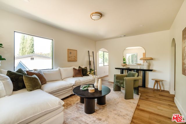 a living room with furniture and wooden floor