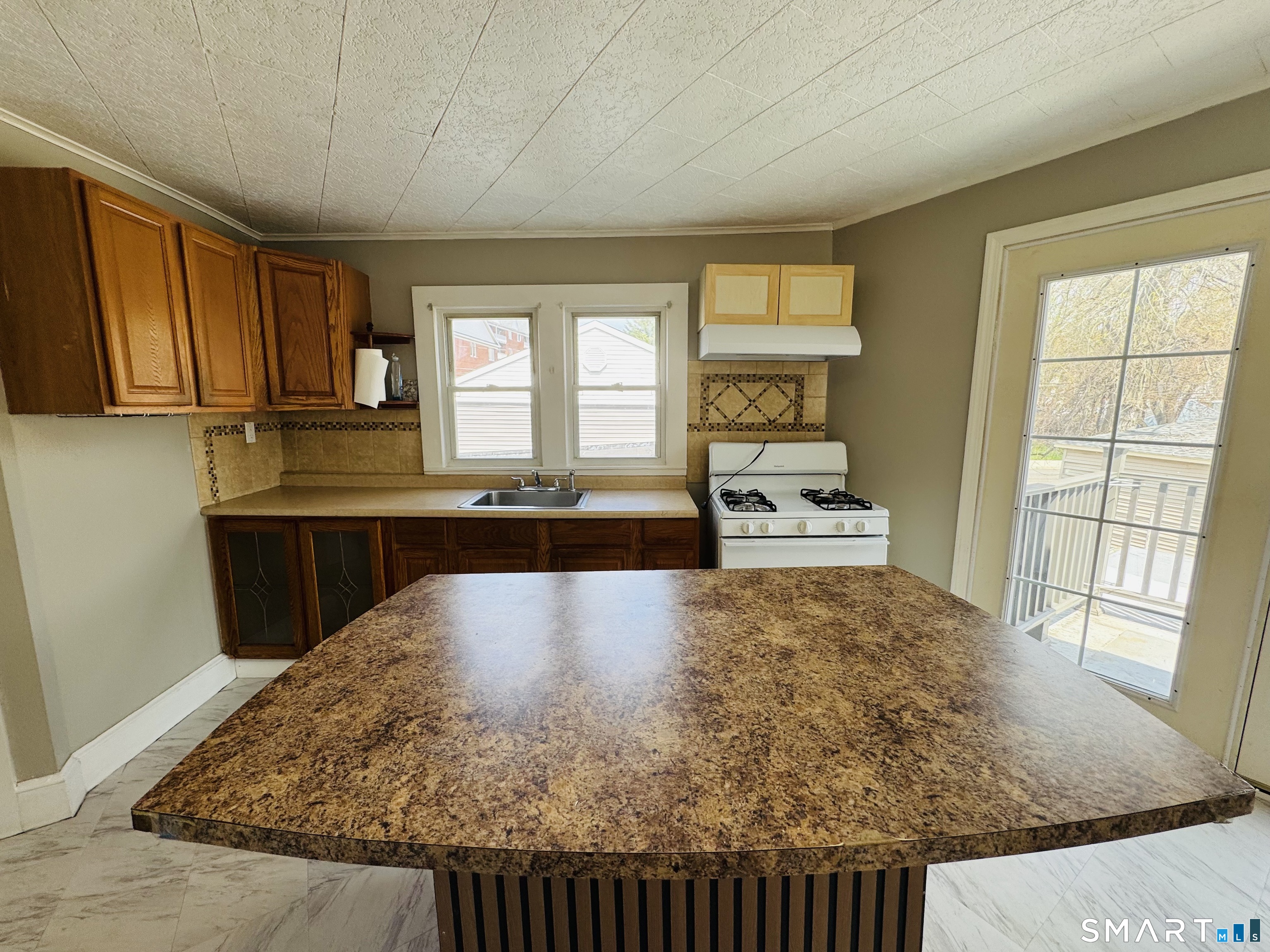 260 Bunker Avenue, Unit 2 Meriden, CT 06450 - Photo 1 of 9 a large kitchen with kitchen island a large window a sink and counter space