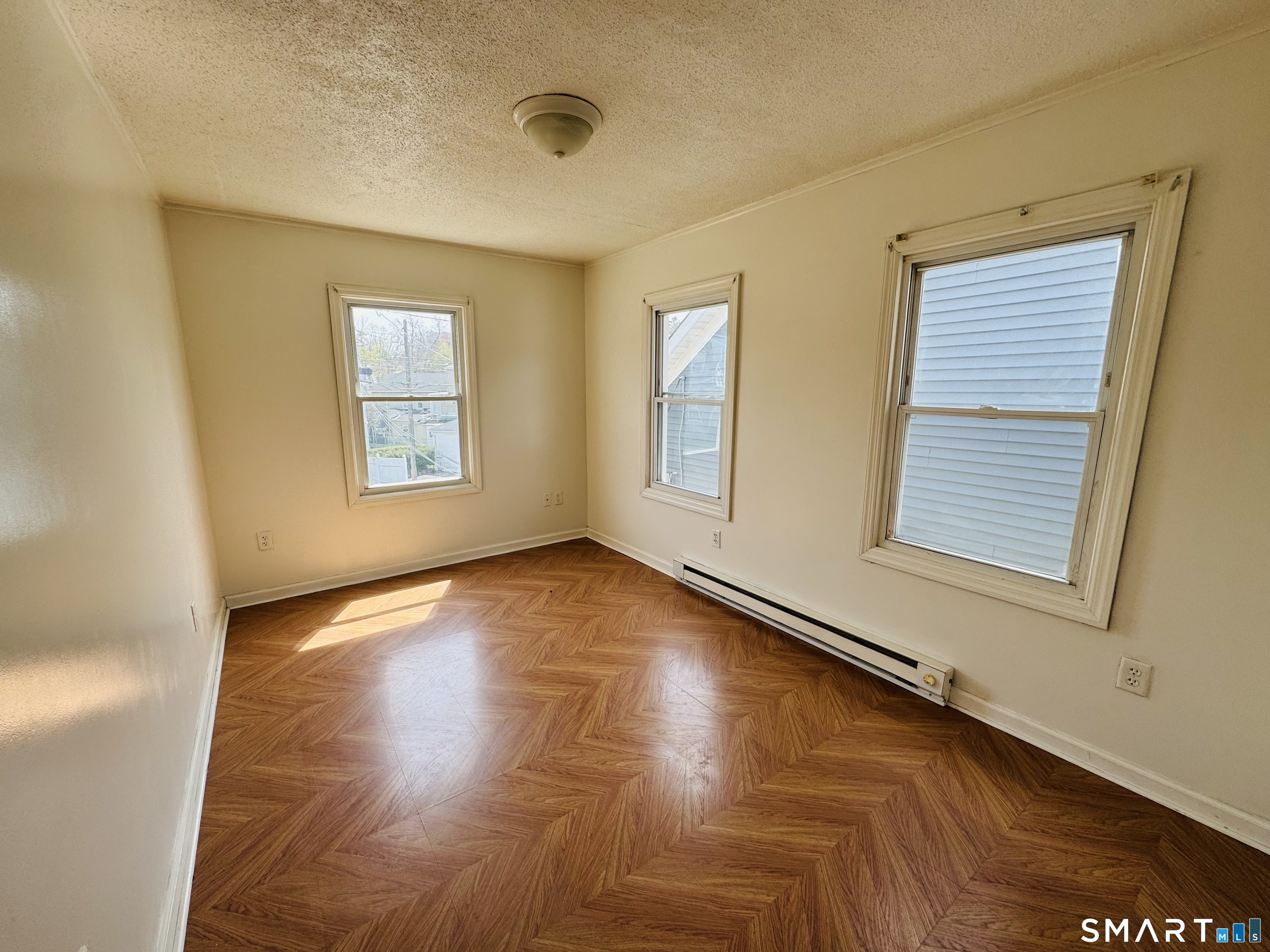 260 Bunker Avenue, Unit 2 Meriden, CT 06450 - Photo 3 of 9 a view of an empty room with a window and wooden floor