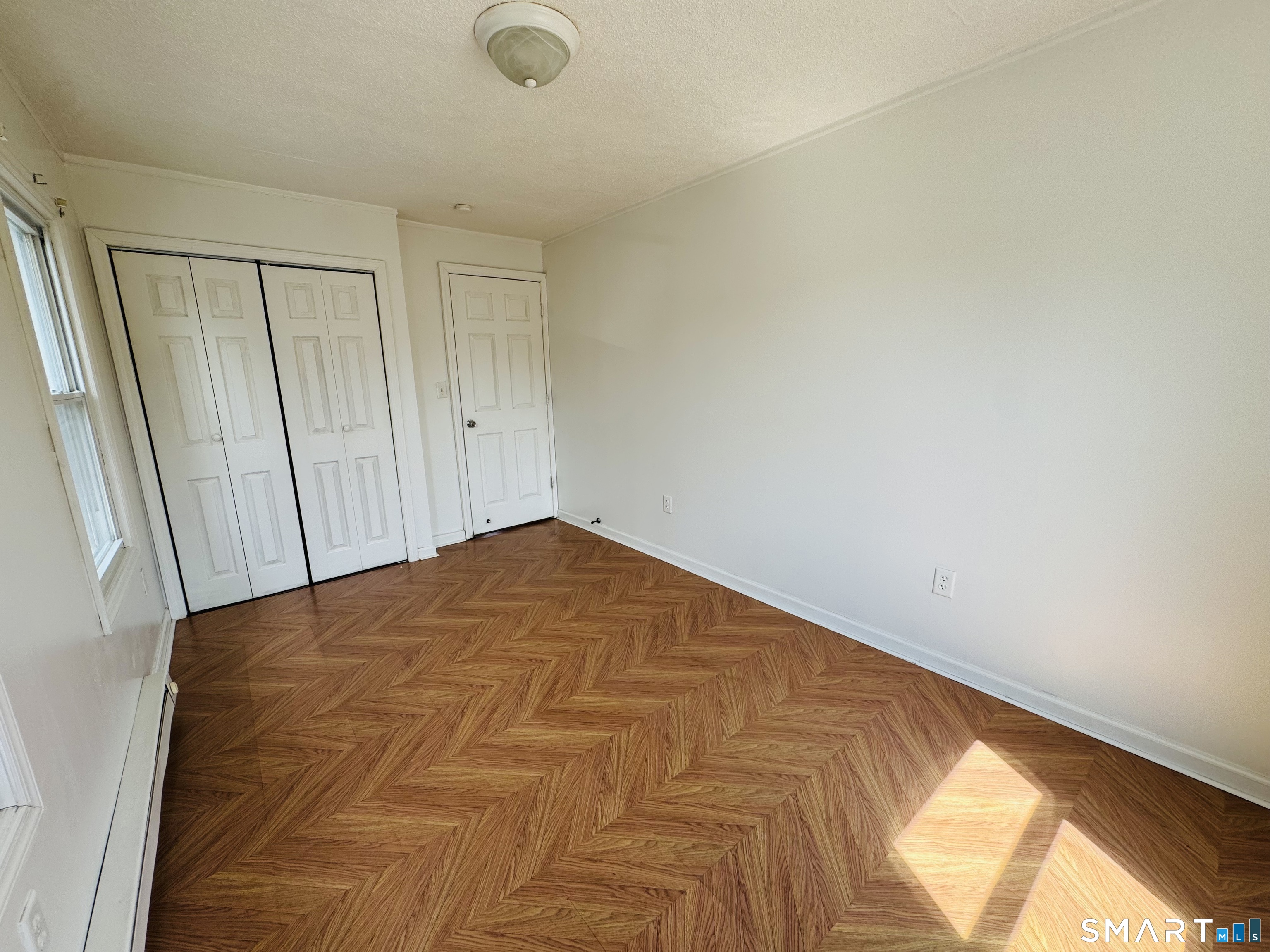 260 Bunker Avenue, Unit 2 Meriden, CT 06450 - Photo 4 of 9 a view of a room with a wooden floor and a window