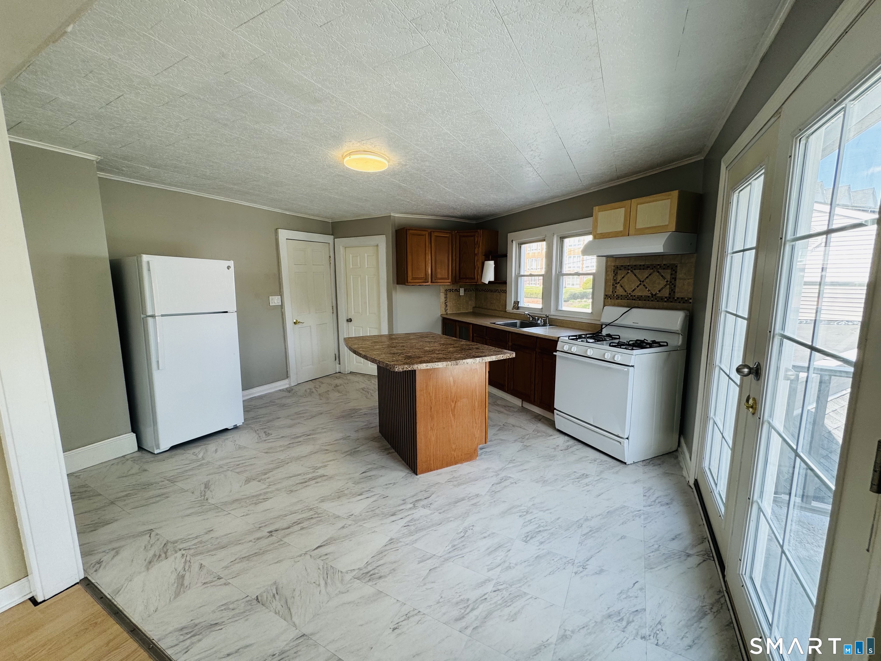 260 Bunker Avenue, Unit 2 Meriden, CT 06450 - Photo 7 of 9 a kitchen with a sink refrigerator and window