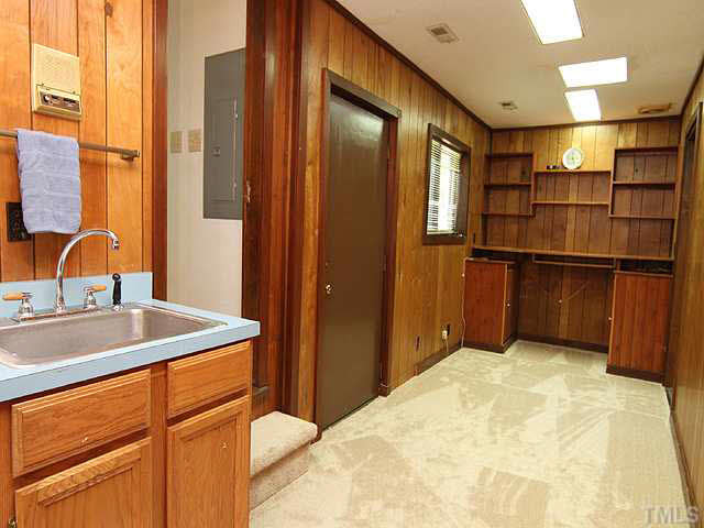 2713 Sherborne Place Raleigh, NC 27612 - Photo 19 of 25 This is between the right garage & study/den and has a door accessing the circular driveway and the door you see here access the side decks! Nice utility sink, cabinet & office built-ins. Skylight! A great multi purpose space for the "handy" home owner. Other