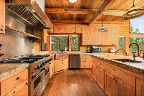 a kitchen with stainless steel appliances granite countertop a stove and a sink