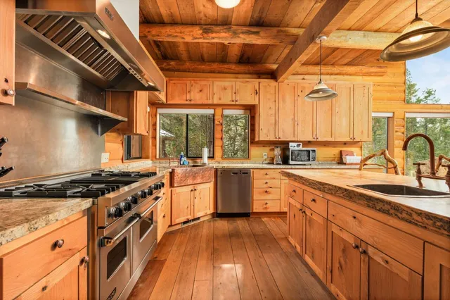 a kitchen with stainless steel appliances granite countertop a stove and a sink
