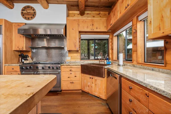 a kitchen with stainless steel appliances granite countertop a sink and cabinets