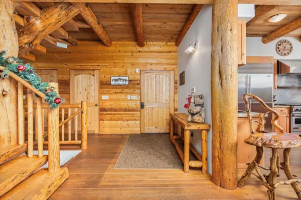 a dinning table and chairs in the kitchen next to a blue building