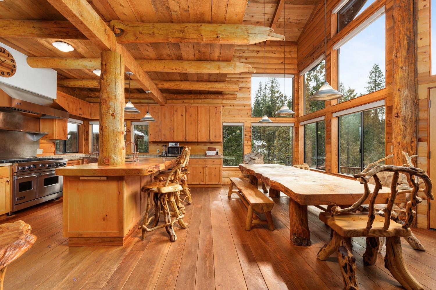 39553 Crest Point Lane Shaver Lake, CA 93664 - Photo 8 of 65 a dinning table and chairs in the kitchen next to a blue building