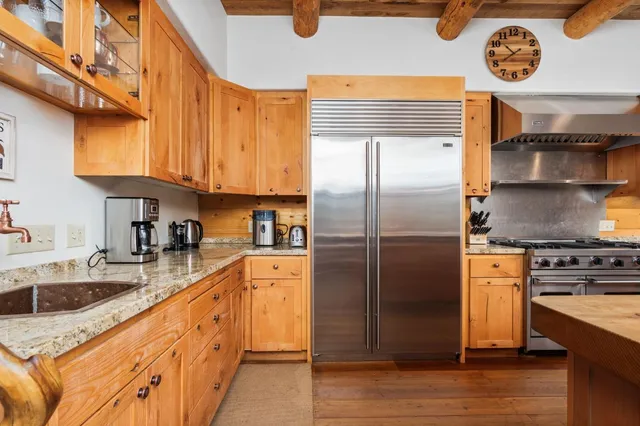a kitchen with stainless steel appliances granite countertop a stove and a sink