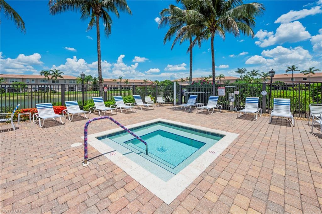 3916 Cherrybrook Loop Fort Myers, FL 33966 - Photo 29 of 31 Outdoor hot tub featuring a paver patio surround, integrated steps, and a metal handrail