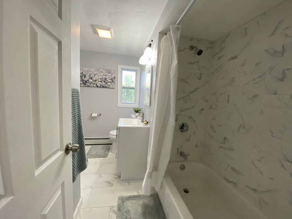 82 Griffin Road Framingham, MA 01701 - Photo 30 of 39 a bathroom with a tub a toilet and a shower