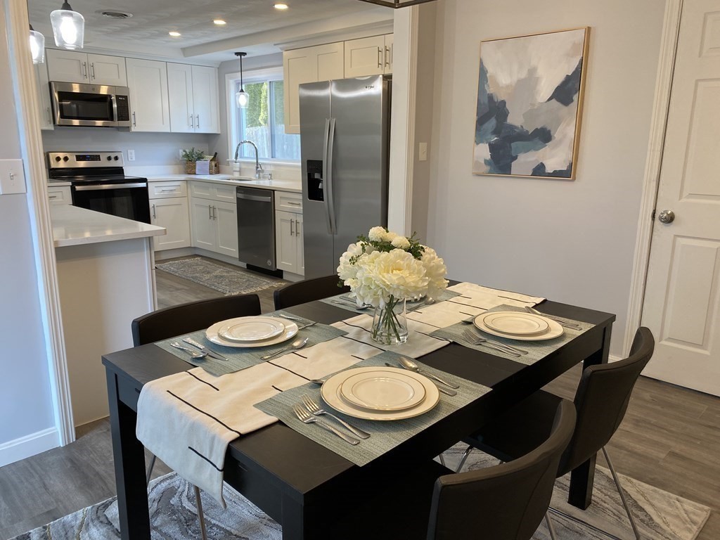 82 Griffin Road Framingham, MA 01701 - Photo 7 of 39 a view of a dining room with furniture kitchen and wooden floor