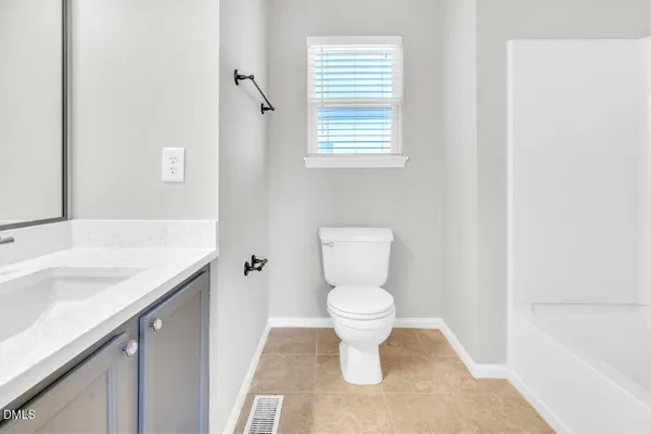 a white toilet sitting next to a bathroom sink