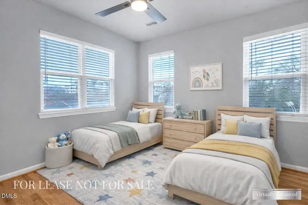 a bedroom with two beds and a large window