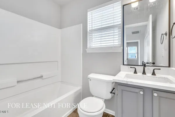 a bathroom with a sink a toilet and a bathtub