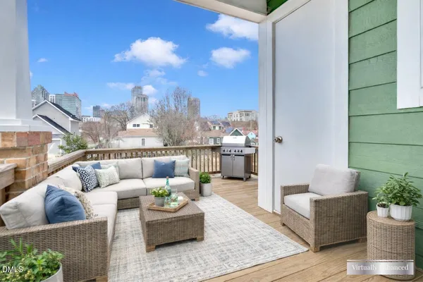 a living room with furniture and a view of kitchen