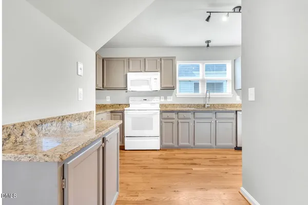 a kitchen with a stove a sink and a refrigerator
