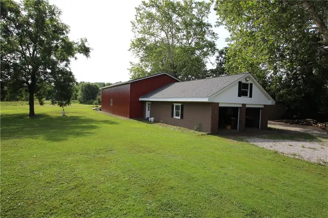 a front view of a house with a yard and trees