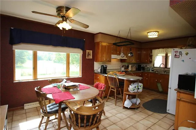 a view of a dining room with furniture a chandelier and window