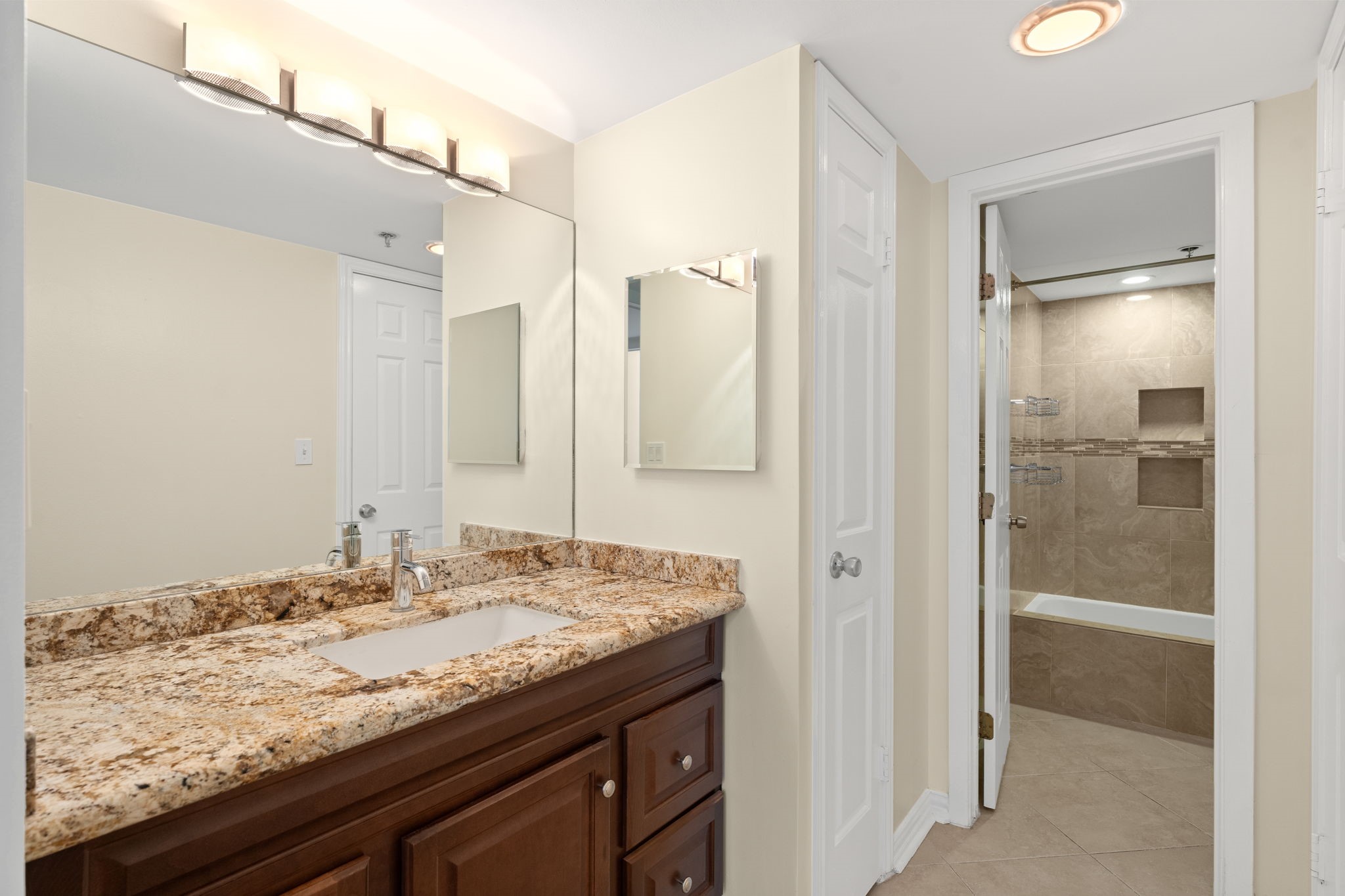 3525 Sage Road, Unit 903 Houston, TX 77056 - Photo 12 of 26 a bathroom with a granite countertop sink and a mirror