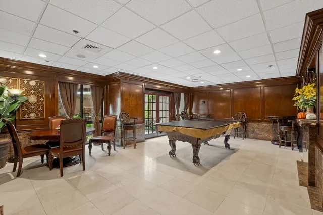 a living room with furniture a rug and white walls