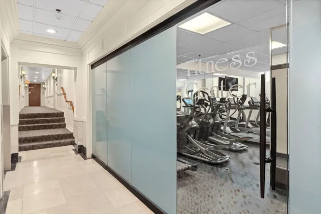 a view of a hallway with a white walls and stairs