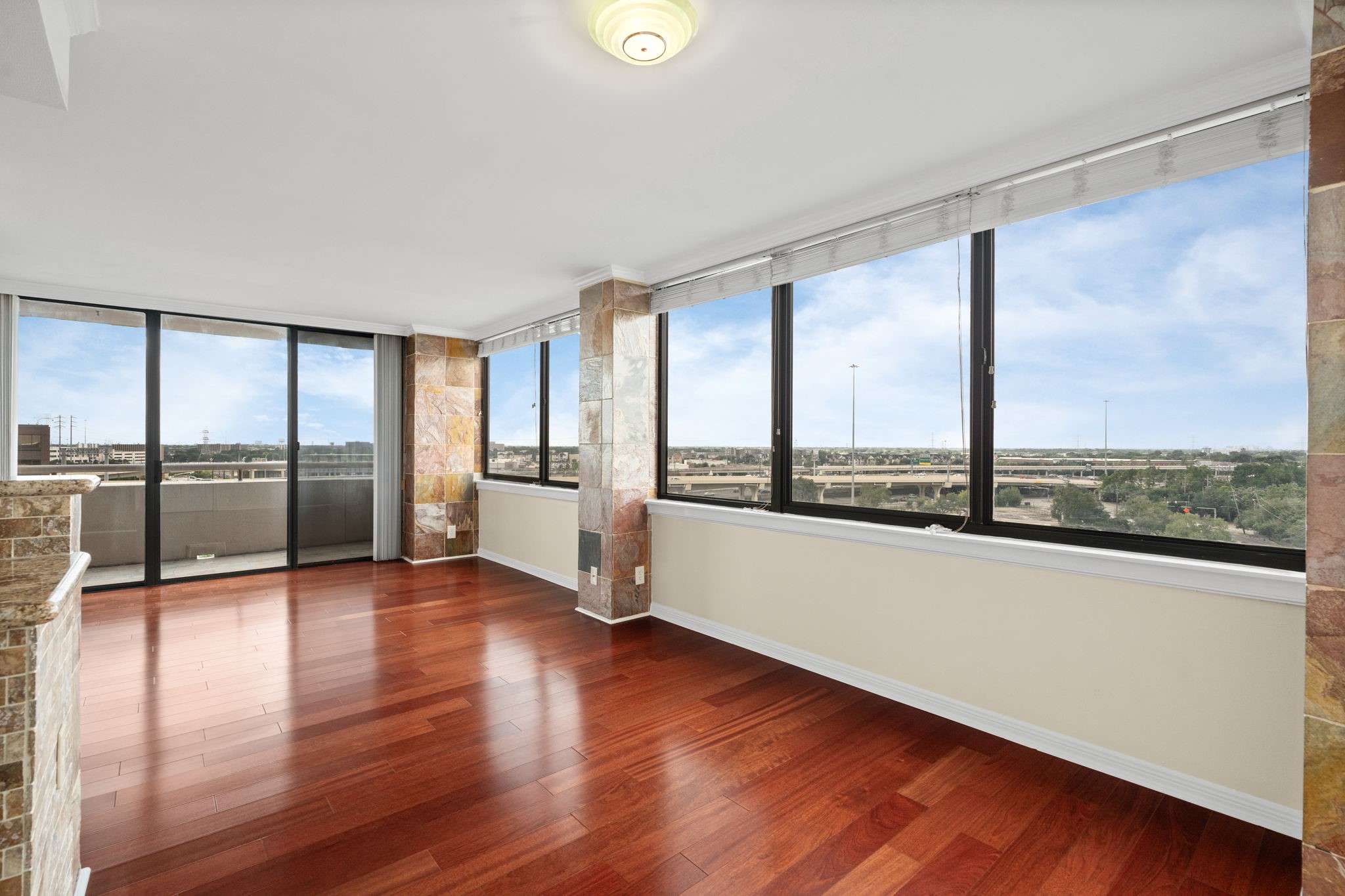 3525 Sage Road, Unit 903 Houston, TX 77056 - Photo 4 of 26 a view of an empty room with wooden floor and a window