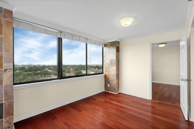 a view of a room with wooden floor and doors