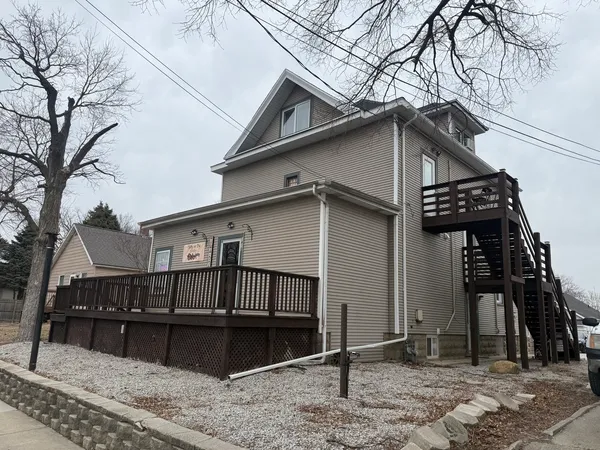 a view of a house with wooden fence
