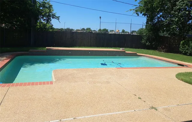 a view of a swimming pool and yard