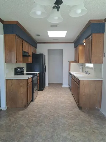 a kitchen with stainless steel appliances granite countertop a stove a sink a refrigerator and a microwave
