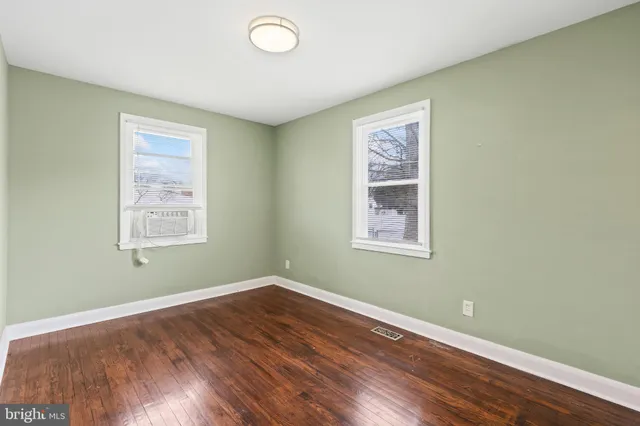 a view of a room with wooden floor and windows