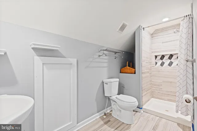 a bathroom with a toilet and a shower